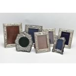 SEVEN MODERN SILVER EASEL BACK PHOTOGRAPH FRAMES, comprising four matching frames of rectangular