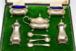 A CASED GEORGE V WALKER & HALL SILVER EIGHT PIECE CRUET SET OF SHAPED RECTANGULAR FORM, wavy rims,