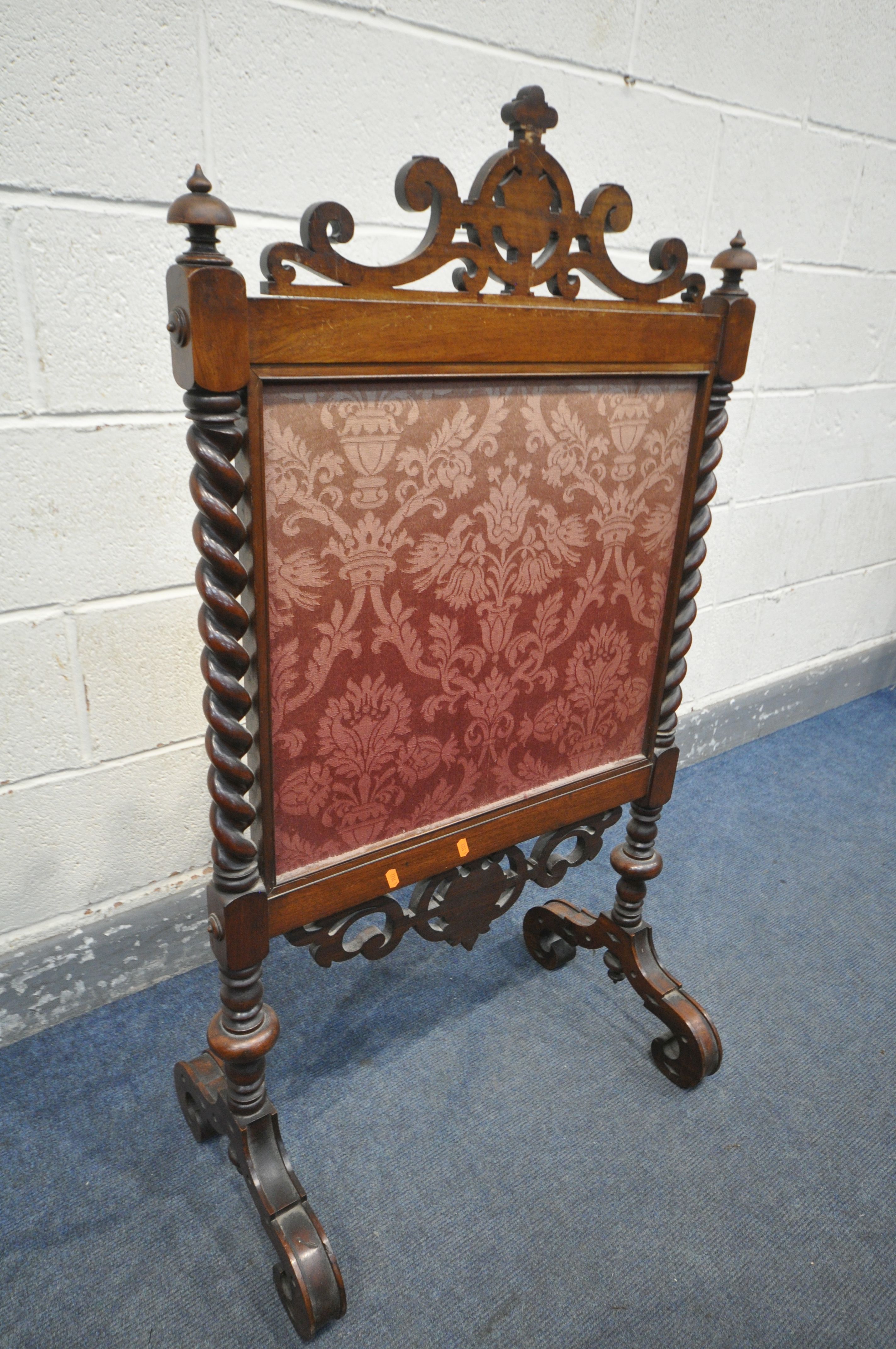 A VICTORIAN WALNUT FIRESCREEN, with open scrolls and central shield, turned finials, barley twist - Image 5 of 5