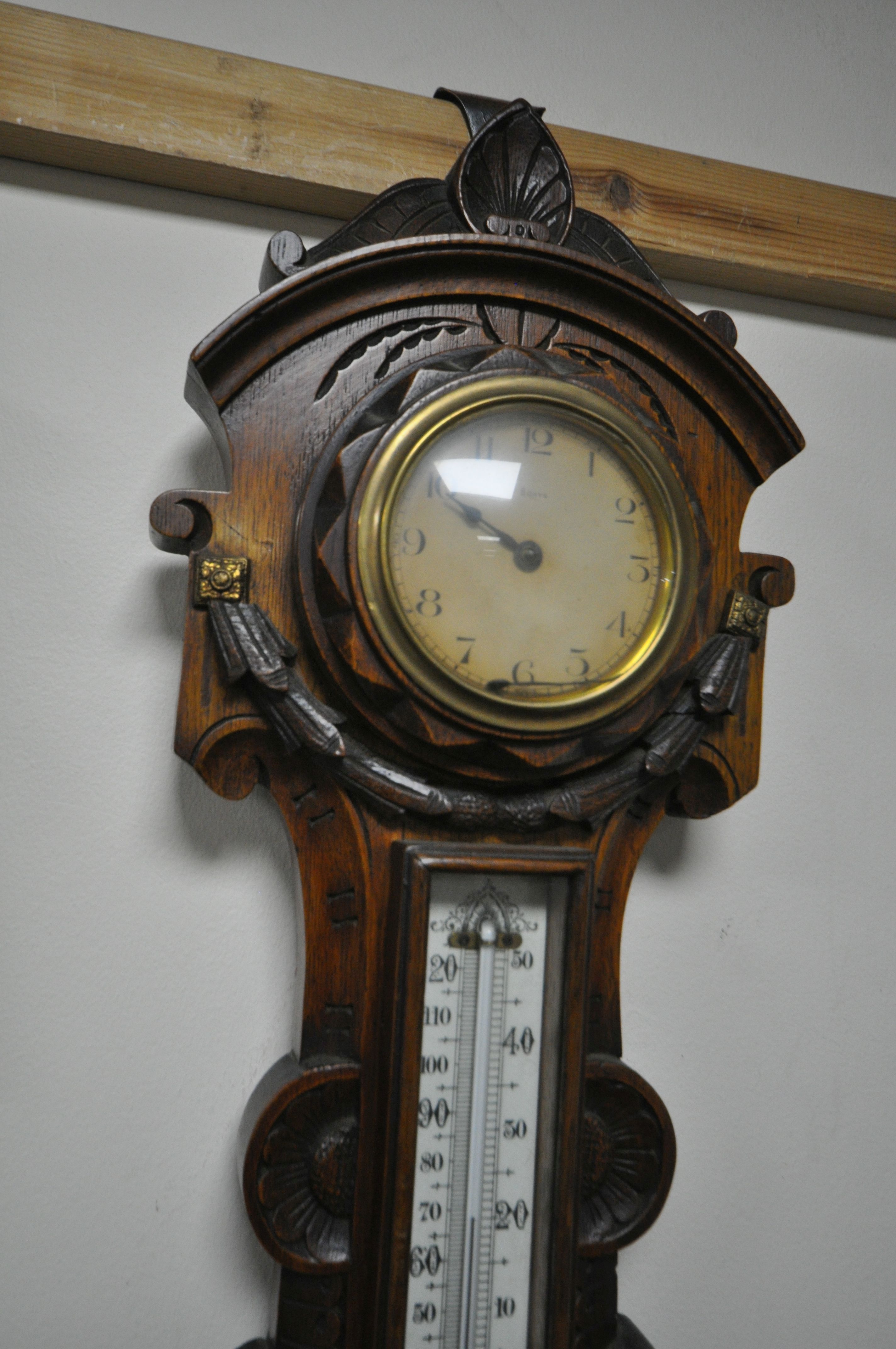 TWO LATE 19TH/EARLY 20TH CENTURY CARVED OAK ANEROID BAROMETERS, with clock dials and thermometers, - Image 4 of 5
