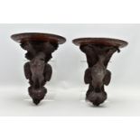 A PAIR OF LATE 19TH CENTURY BLACK FOREST CARVED OAK WALL BRACKETS, the demi-lune shelf over a game