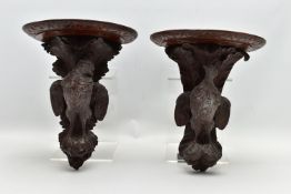 A PAIR OF LATE 19TH CENTURY BLACK FOREST CARVED OAK WALL BRACKETS, the demi-lune shelf over a game