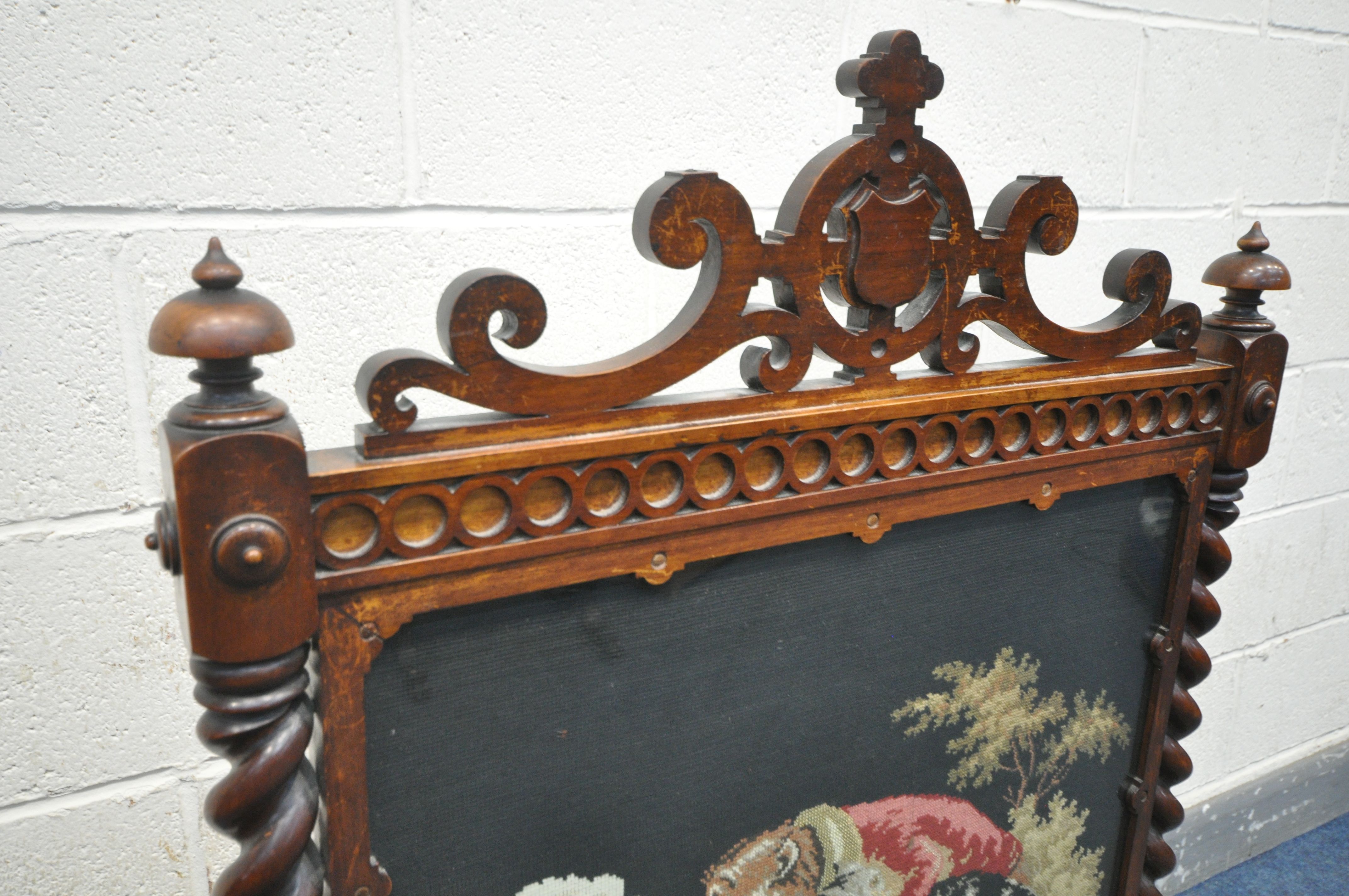 A VICTORIAN WALNUT FIRESCREEN, with open scrolls and central shield, turned finials, barley twist - Image 3 of 5