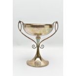 A GEORGE V SILVER TWIN HANDLED TROPHY CUP, the shallow silver cup on a slender pedestal with cast