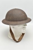 WW2 ERA British steel helmet, complete with inner head liner and canvas strap, the helmet is maker