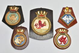 FIVE ROYAL NAVAL PERIOD SHIPS CRESTS ALL MOUNTED ON WOODEN HANGING PLINTHS, wood and plaster