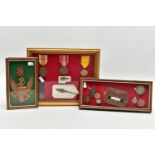 THREE GLAZED FRAMES CONTAINING MEDALS, BADGES, COINS, to include German Westwall Medal arrowhead