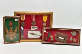 THREE GLAZED FRAMES CONTAINING MEDALS, BADGES, COINS, to include German Westwall Medal arrowhead