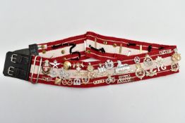 A RED AND WHITE MILITARY STYLE STABLE BELT, which has had mounted over 45 Military Badges, Cap