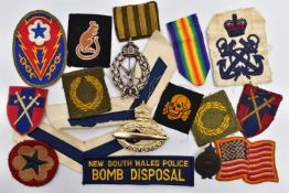 A BOX CONTAINING A NUMBER OF MILITARY PATCHES, US, BRITISH AND GERMAN, together with three