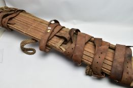 A WW1/2 ERA MILITARY EXTRICATION STRETCHER, wood/canvas construction, has many fastening securing