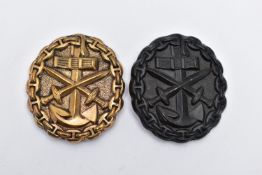 TWO EXAMPLES OF THE GERMAN WW2 KRIEGSMARINE WOUND BADGE, one gold, one black finish, both die