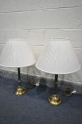 A PAIR OF BRASS COLUMN TABLE LAMPS, with fabric shades, height 72cm