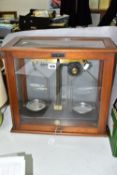 AN OAK CASED SET OF GRIFFIN & TATLOCK LTD SCIENTIFIC SCALES, the Bakelite base marked with maker's