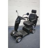 A KOMFY 4 MOBILITY SCOOTER, in a black finish, complete with key, charger, manual, and sales receipt