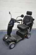 A KOMFY 4 MOBILITY SCOOTER, in a black finish, complete with key, charger, manual, and sales receipt