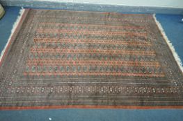 A WOOLLEN TEKKE CARPET, with a pink field, 274cm x 192cm (condition:-good condition apart from