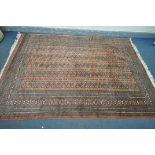 A WOOLLEN TEKKE CARPET, with a pink field, 274cm x 192cm (condition:-good condition apart from