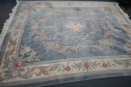 A LARGE RECTANGULAR BLUE GROUND CHINESE WOOLEN RUG, with multistrap border, and foliate decorations,