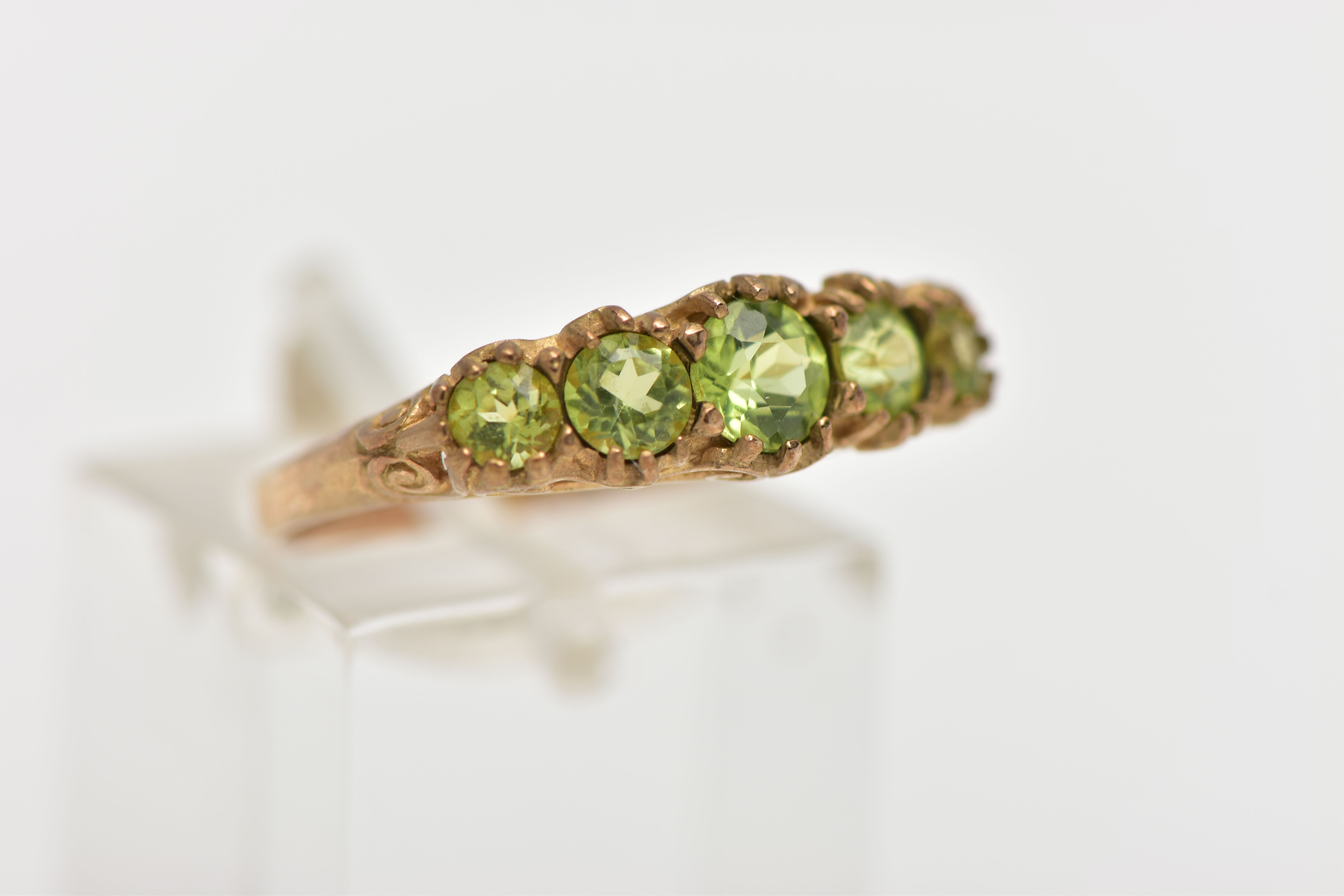 A 9CT GOLD FIVE STONE PERIDOT RING, designed with five graduated circular cut peridots, scrolling - Image 4 of 4