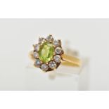 AN 18CT GOLD PERIDOT AND DIAMOND CLUSTER RING, the oval cut peridot, with brilliant cut diamond