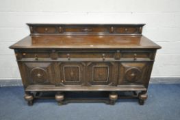 A 20TH CENTURY SOLID OAK SIDEBOARD, with a raised back, three drawers, left drawer with green
