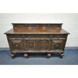 A 20TH CENTURY SOLID OAK SIDEBOARD, with a raised back, three drawers, left drawer with green