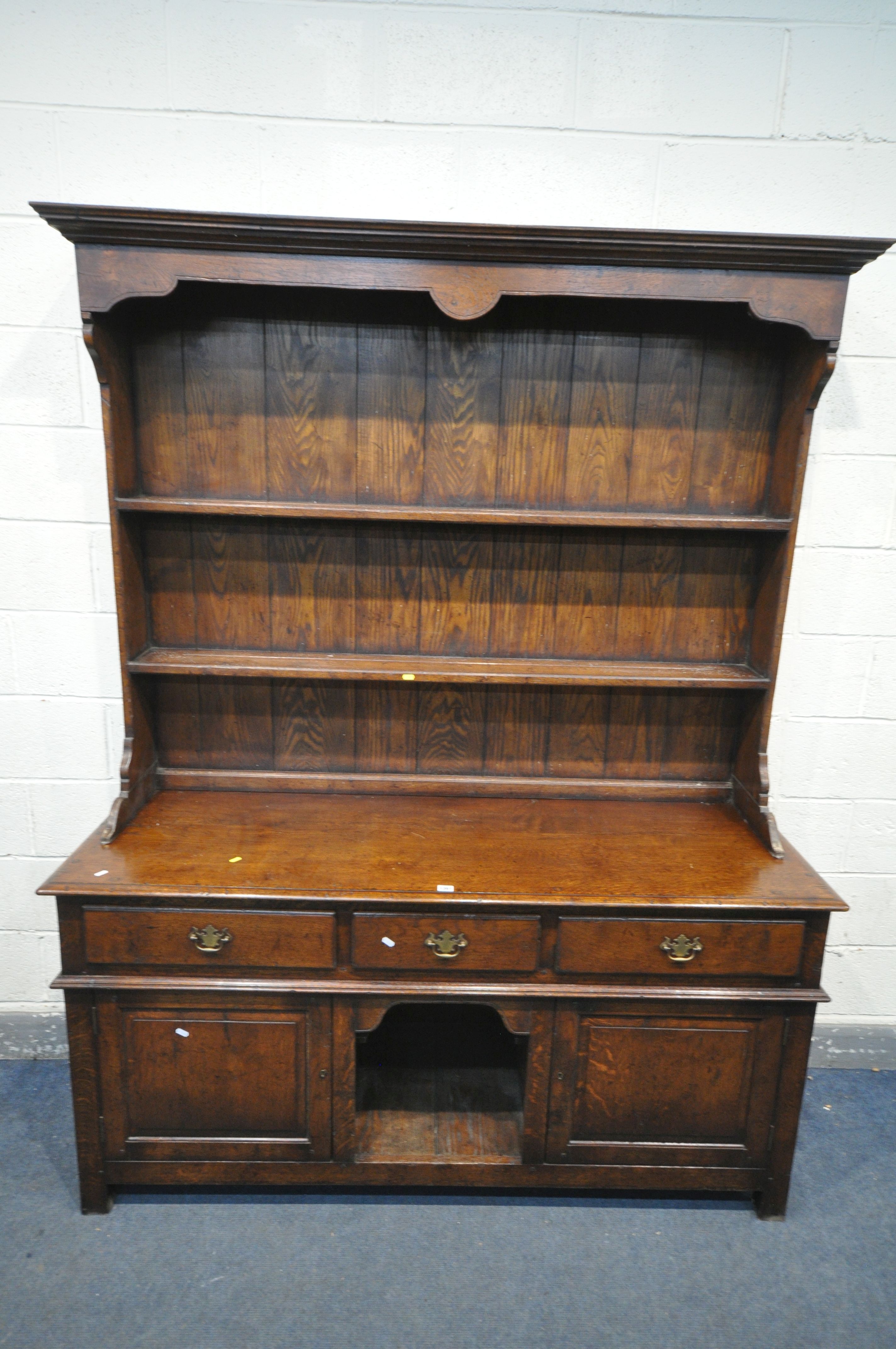 A REPRODUCTION GEORGIAN STYLE OAK DRESSER, with two shelves, over a base with three drawers, two