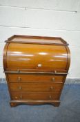 AN EDWARDIAN MAHOGANY AND INLAID BARREL FRONT BUREAU, with fitted interior, a pull out slide with