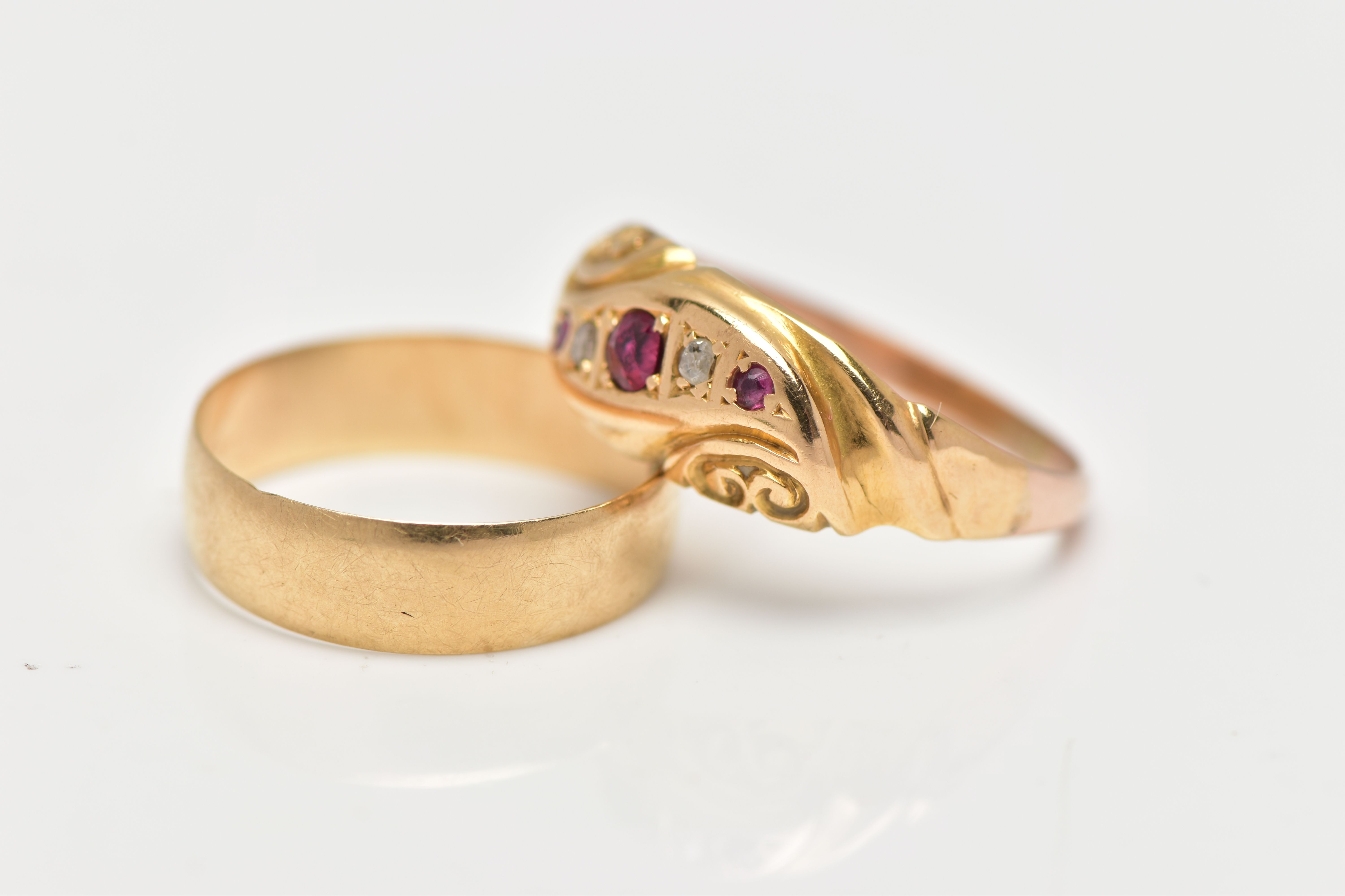 TWO EARLY 20TH CENTURY GOLD RINGS, the first a plain polished yellow gold band ring, approximate - Image 2 of 3