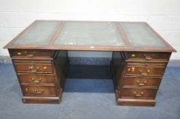 A REPRODUCTION MAHOGANY PEDESTAL DESK, teal leather writing surface, with an arrangement of six