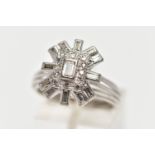 A WHITE METAL DIAMOND CLUSTER RING, raised cluster centring on a rectangular cut diamond in a collet