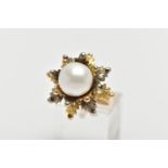 A WHITE AND YELLOW METAL CULTURED PEARL RING, of foliate design, set with a principal part drilled