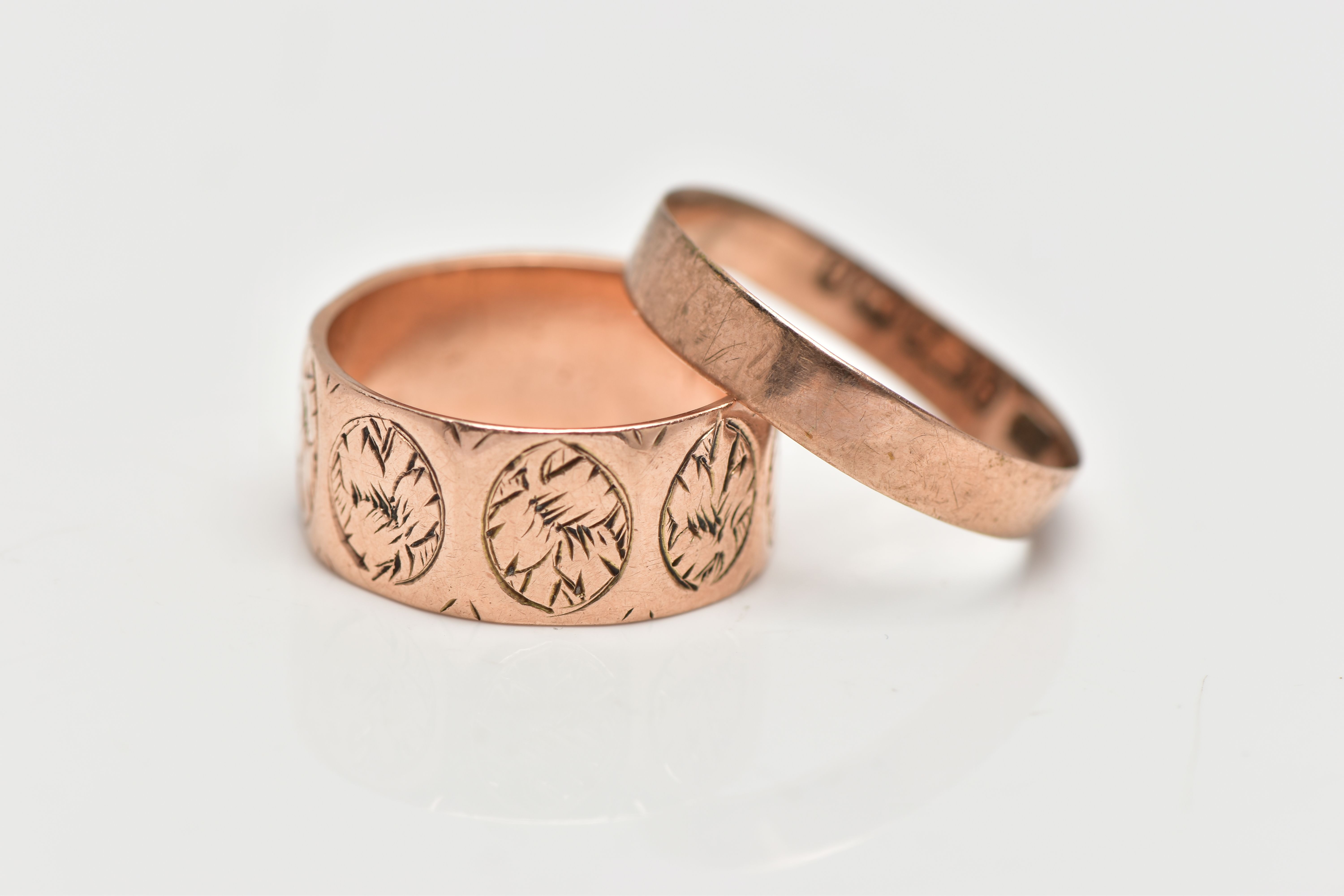 TWO LATE VICTORIAN 9CT ROSE GOLD BAND RINGS, the first comprising engraved foliate oval repeating