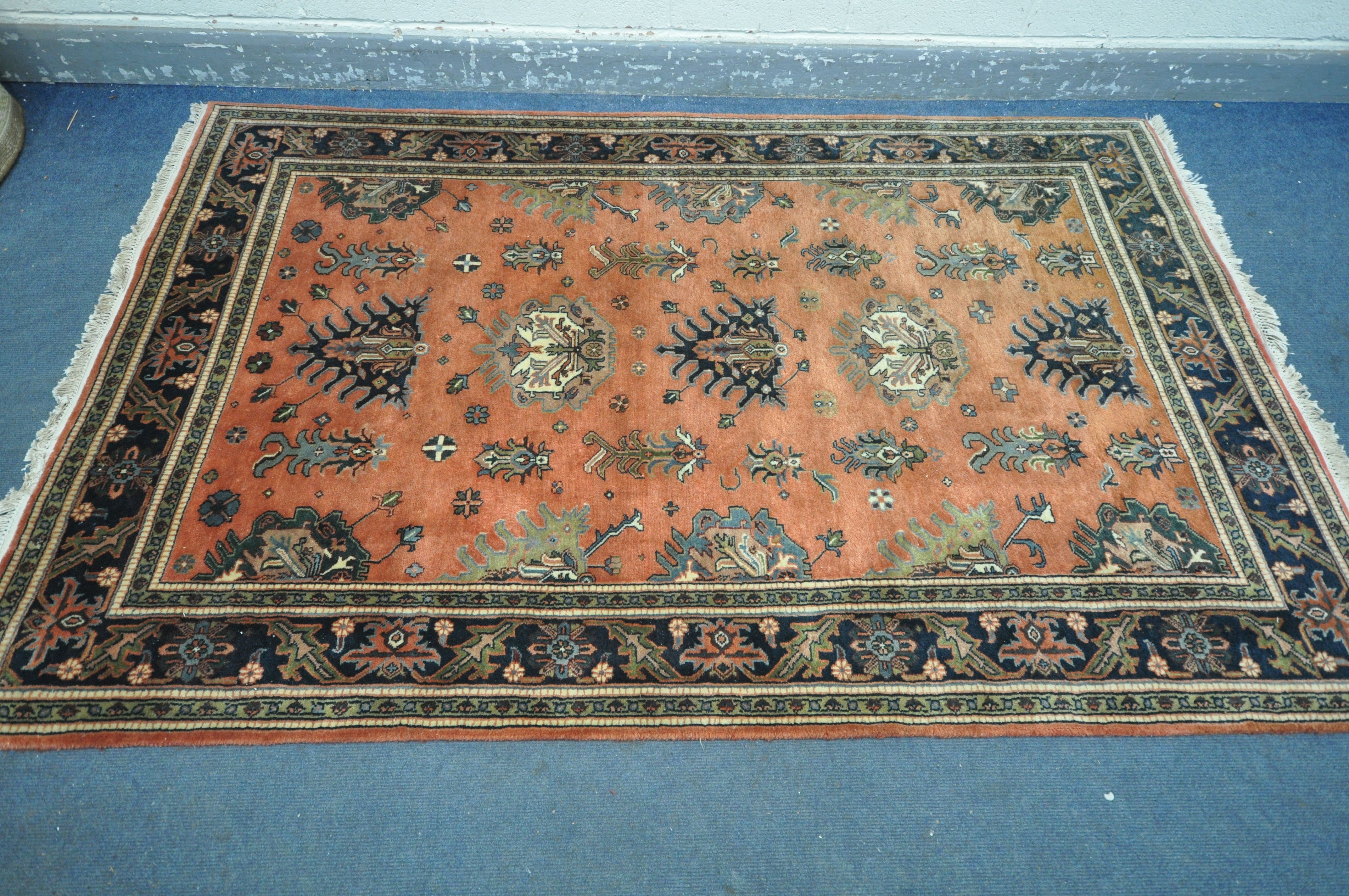A 20TH CENTURY KULA RUG, with a red field, 250cm x 157cm, along with a gold floral rug, 215cm x