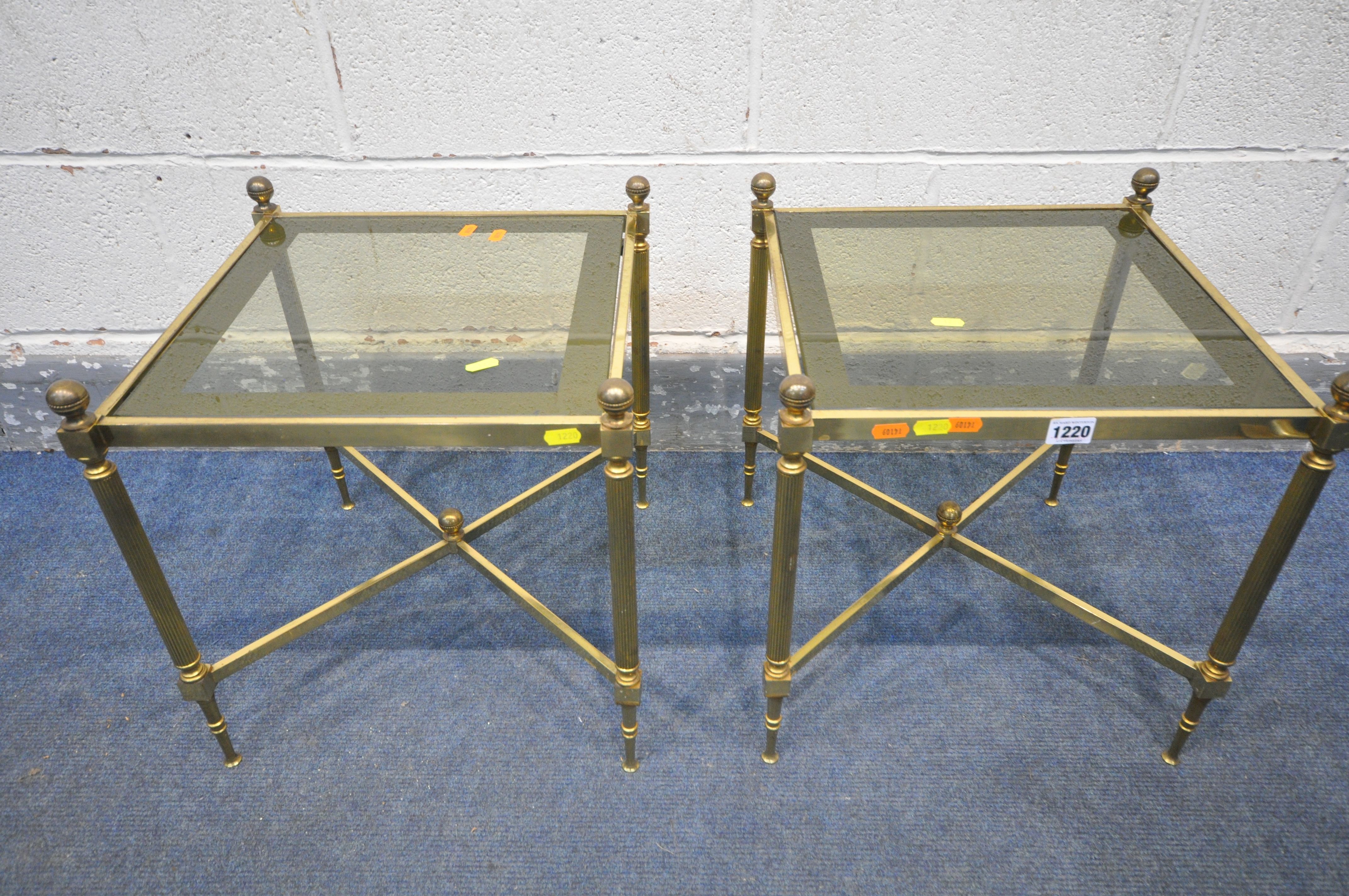 A PAIR OF MAISON JANSEN STYLE FRENCH BRASS SIDE TABLES, with smoked glass inserts, on Corinthian