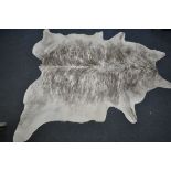 A LARGE EXOTIC COW HIDE RUG, length 206cm x width 155cm (condition - small piece missing to edge