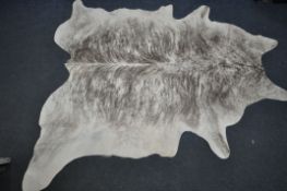 A LARGE EXOTIC COW HIDE RUG, length 206cm x width 155cm (condition - small piece missing to edge