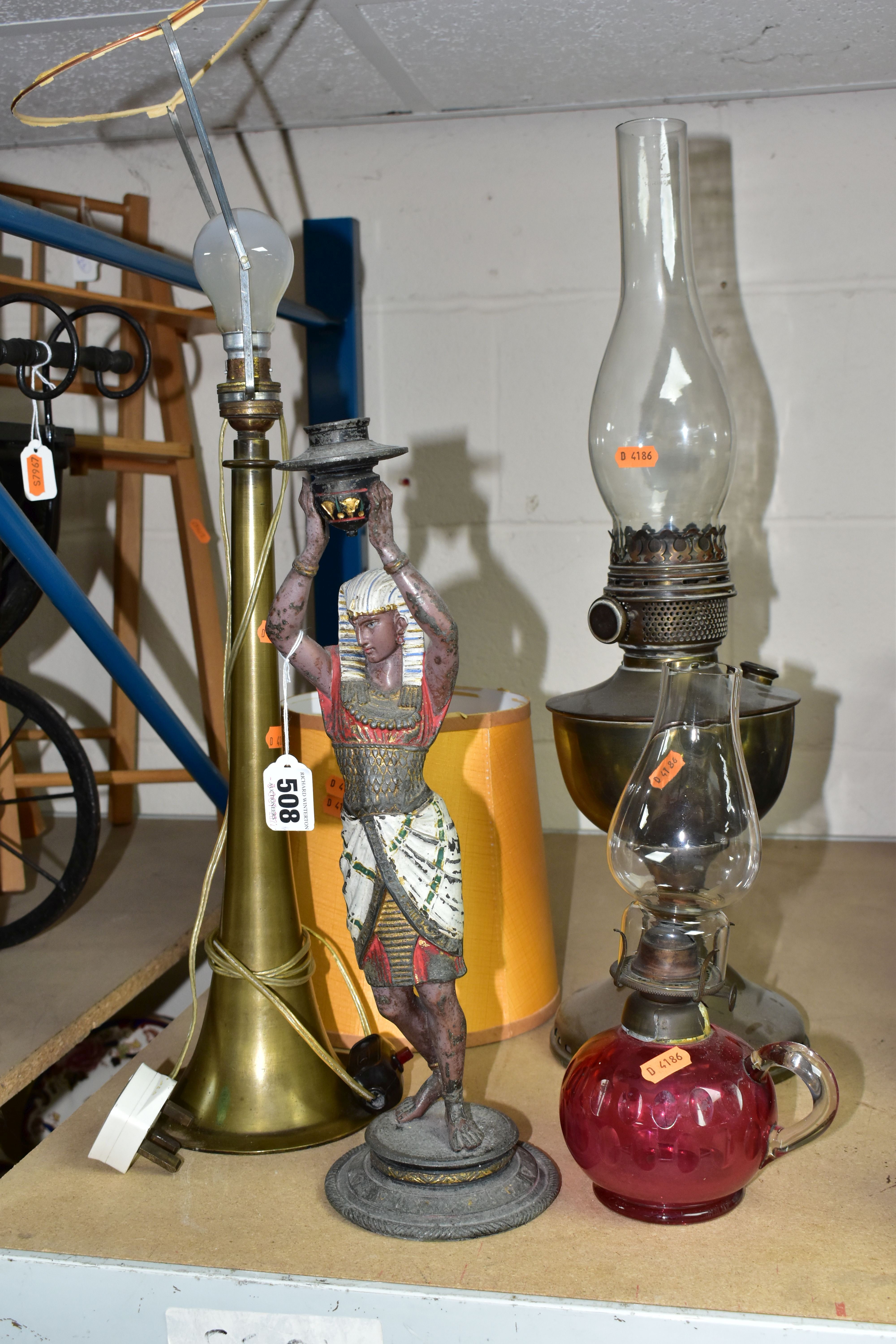 A GROUP OF FOUR LAMPS, comprising a brass oil lamp, height 56cm to top of glass chimney (no
