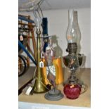 A GROUP OF FOUR LAMPS, comprising a brass oil lamp, height 56cm to top of glass chimney (no