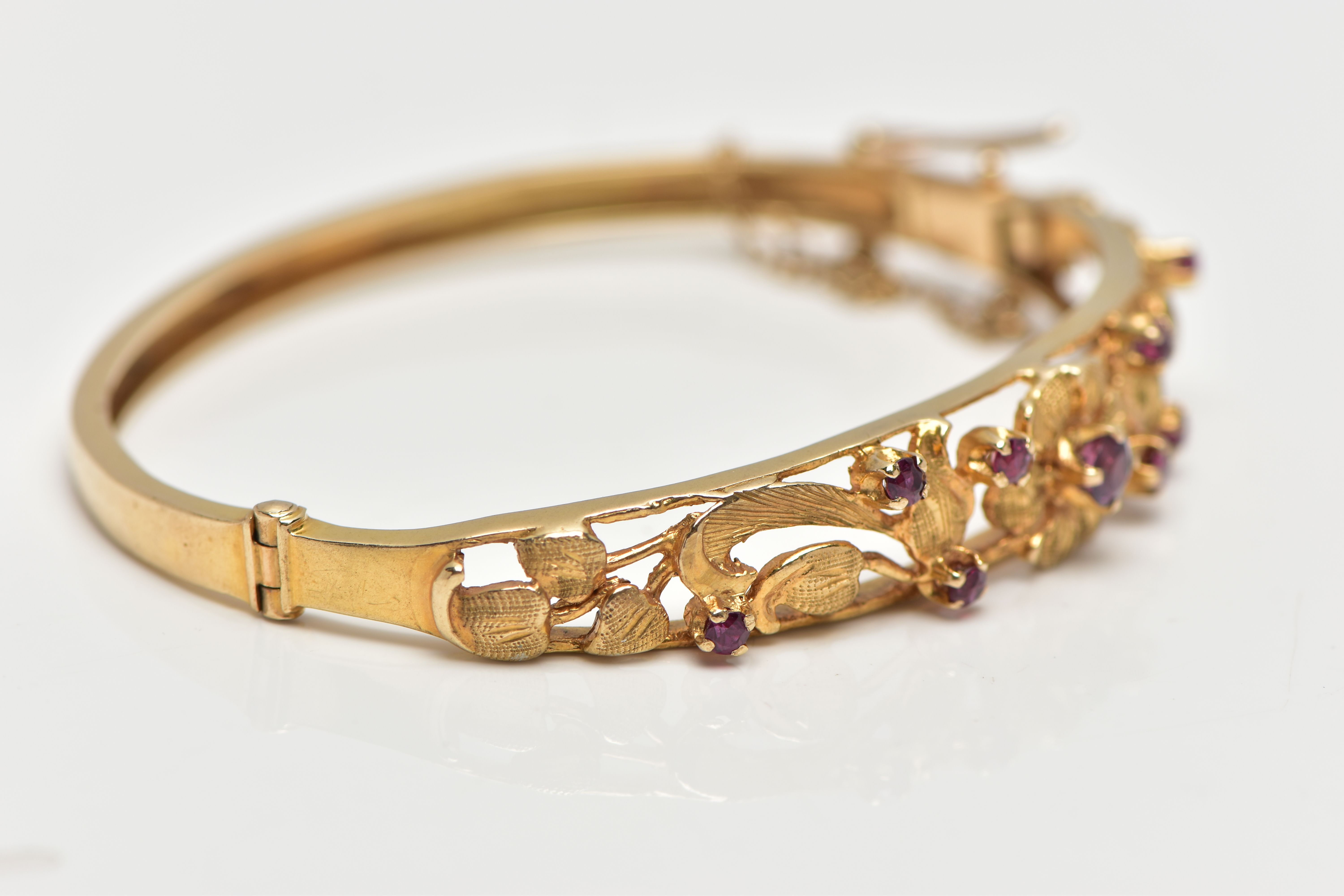 A 9CT GOLD FLORAL BANGLE, a yellow gold oval form hinged bangle, open work textured detail set - Bild 3 aus 6