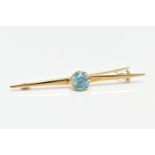 A YELLOW METAL ZIRCON BAR BROOCH, set with a circular blue zircon, measuring approximately 8.5mm x