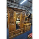 AN EARLY 20TH CENTURY CARVED OAK BEDROOM SUITE, comprising a single mirror door wardrobe, with a