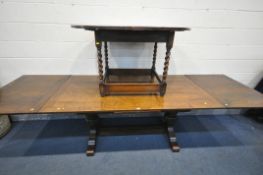 A REPRODUCTION OAK DRAW LEAF REFECTORY TABLE, on a twin turned base, united by a stretcher, extended