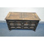 A 20TH CENTURY OAK STORAGE CHEST, with hinged lid, with geometric patterns to front, width 122cm x