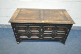 A 20TH CENTURY OAK STORAGE CHEST, with hinged lid, with geometric patterns to front, width 122cm x