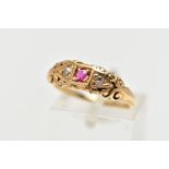 AN EARLY 20TH CENTURY 18CT GOLD RUBY AND DIAMOND RING, set with a central circular cut ruby, flanked