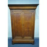 AN EARLY 20TH CENTURY OAK FRENCH ARMOIRE, the double panelled doors over a single long drawer, on