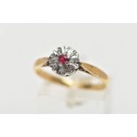 A YELLOW METAL DIAMOND AND RUBY CLUSTER RING, flower design, centring on a circular cut glass filled