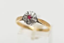 A YELLOW METAL DIAMOND AND RUBY CLUSTER RING, flower design, centring on a circular cut glass filled